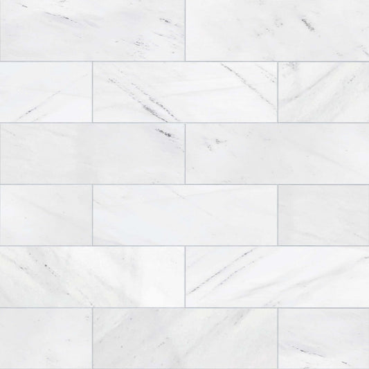 White marble tiles arranged in a herringbone pattern