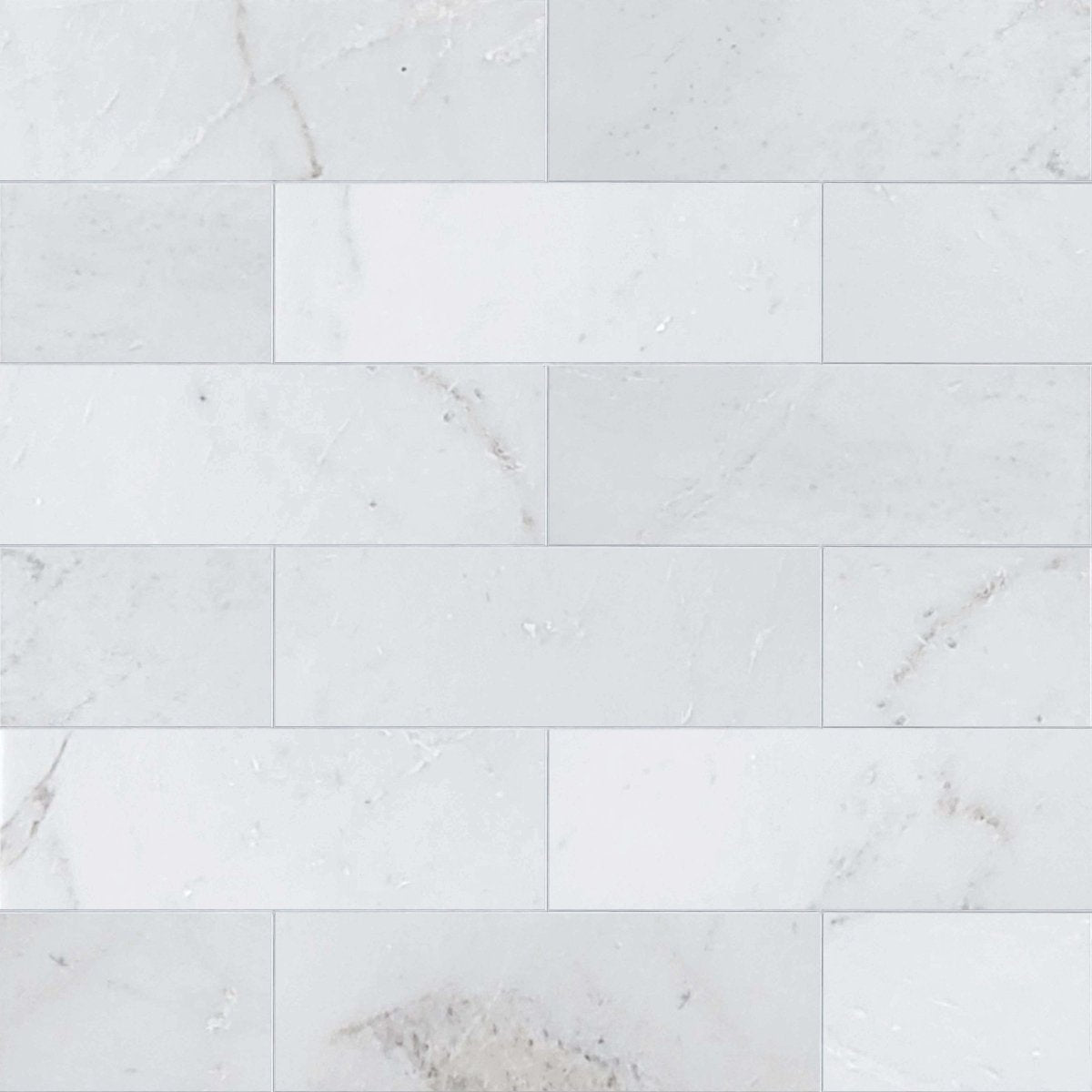 White marble tiles with subtle gray veining on a white background