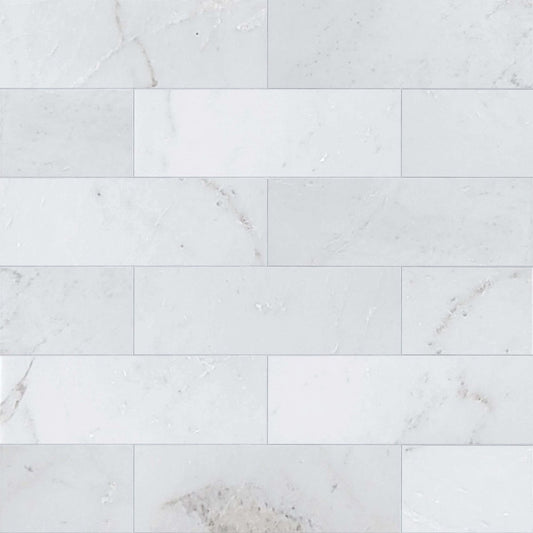 White marble tiles with subtle gray veining on a white background