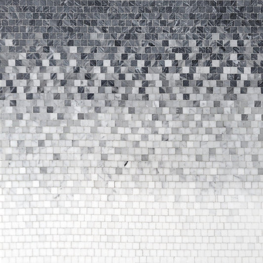 Mosaic pattern of small square tiles in gray and white on a white background