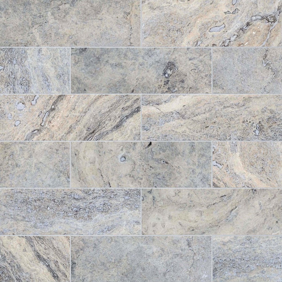 Pattern of gray and beige tiles with a marble-like texture.